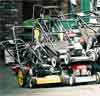 stack of lawn mowers